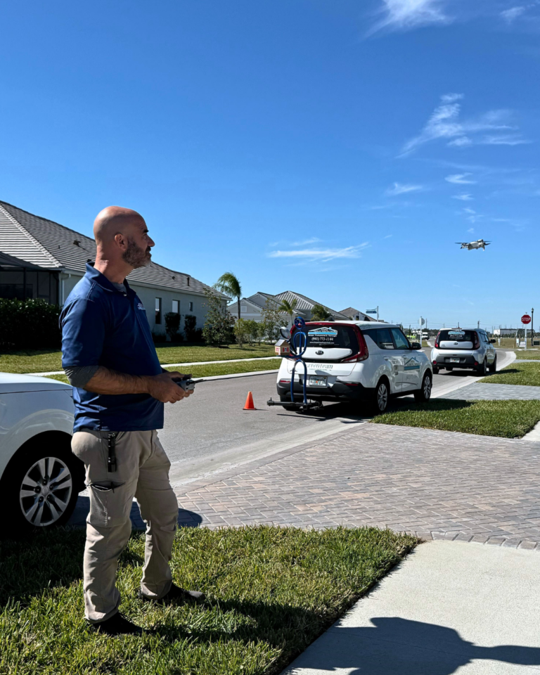 Home inspector flying a drone over a homes roof
