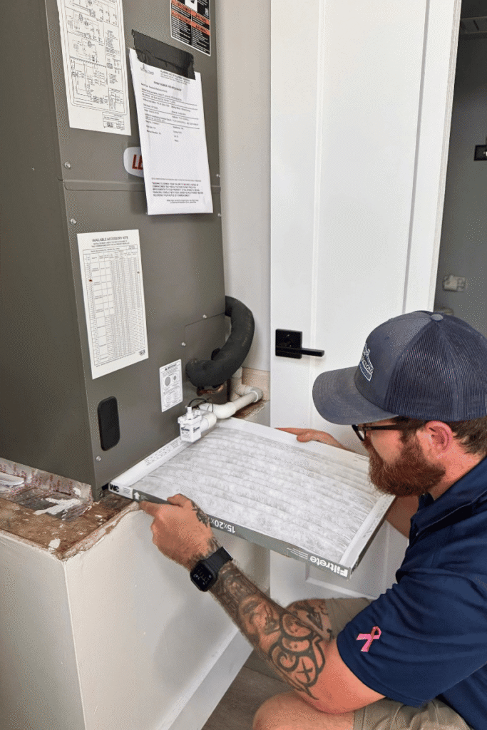 Home inspector performing a maintenance inspection on the HVAC handler 
